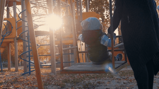 Child on a swing with an adult. Text reads: Swing Into Self-Confidence: Increase children's confidence along with your own.