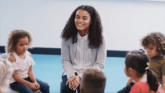 Image of educator smiling with children and text that reads: Conversations with Kids: Supporting communicating and speaking skills